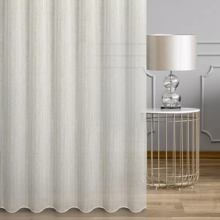 Firana szyta na tunelu kremowa z tkaniny o luźnym splocie, z delikatnie błyszczącą nicią, wykończona obciążnikiem