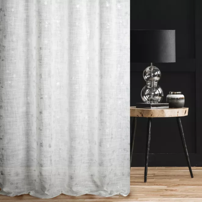 Zasłona szyta na przelotkach kremowo srebrzysta z tkaniny w stylu eko z błyszczącym nadrukiem