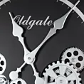 Okrągły zegar ścienny w metalowej ramie z ruchomymi kołami zębatymi Eurofirany